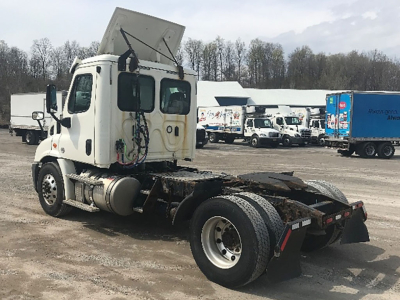 Truck chassis and cab of a 2018 Freightliner Cascadia113 tractor viewed from rear-left, showing fifth-wheel mounting plate and rear dual tires.
