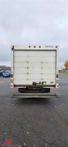 GMC Savana 3500 cutaway rear view showing cargo box doors and rear bumper.