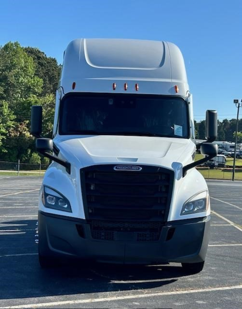 Conventional sleeper truck front view of a white 2023 Freightliner Cascadia 126 with black grille and large side mirrors.