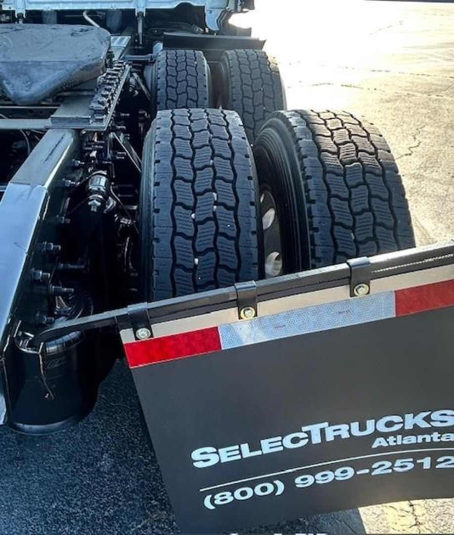 Freightliner Cascadia 126 rear tractor wheels showing dual axles and mudflap with SelectTrucks Atlanta branding.