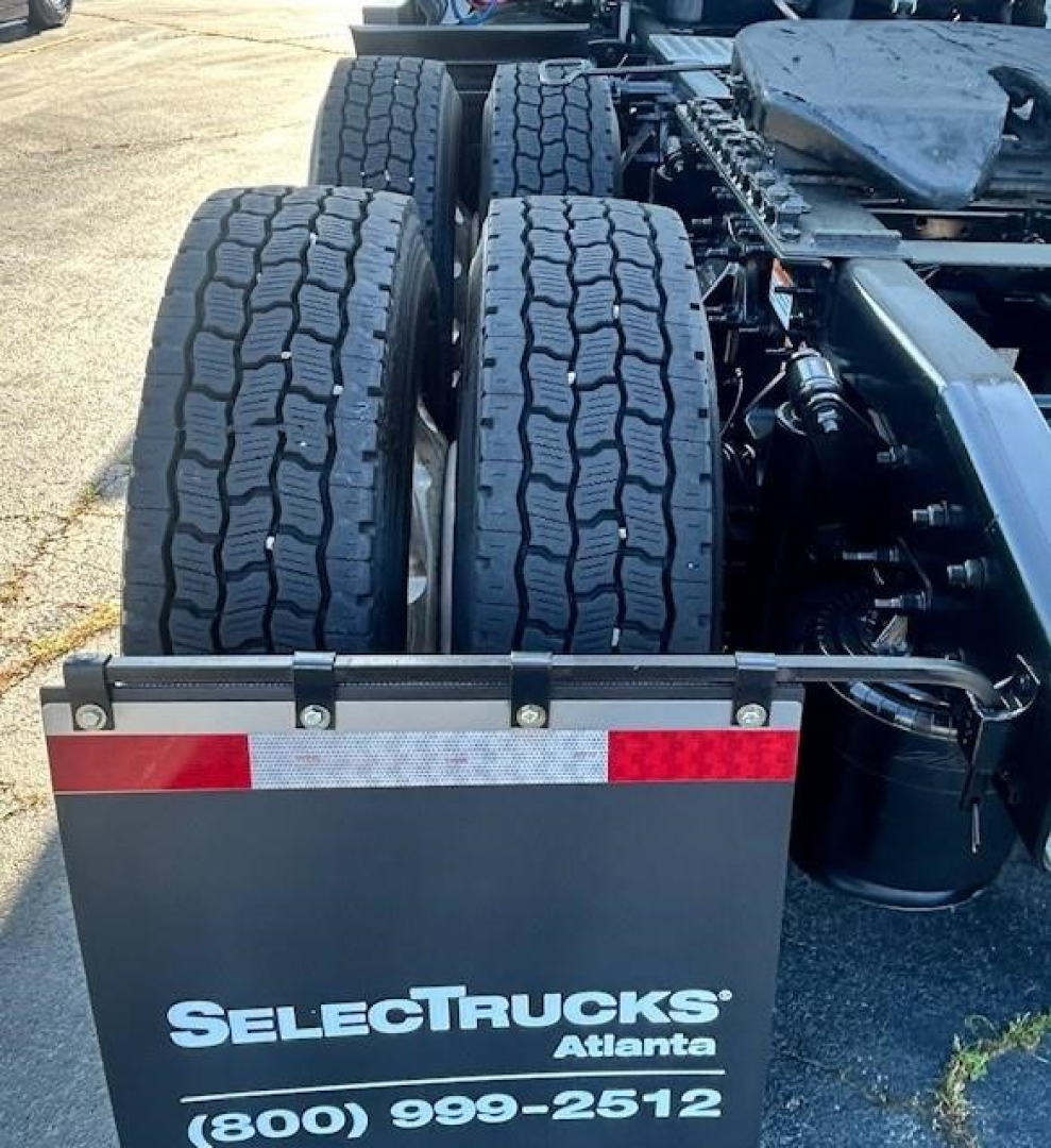 Rear view of a Freightliner Cascadia truck showing dual rear axles and five wheels, with SelectTrucks Atlanta branding visible on the mudguard.