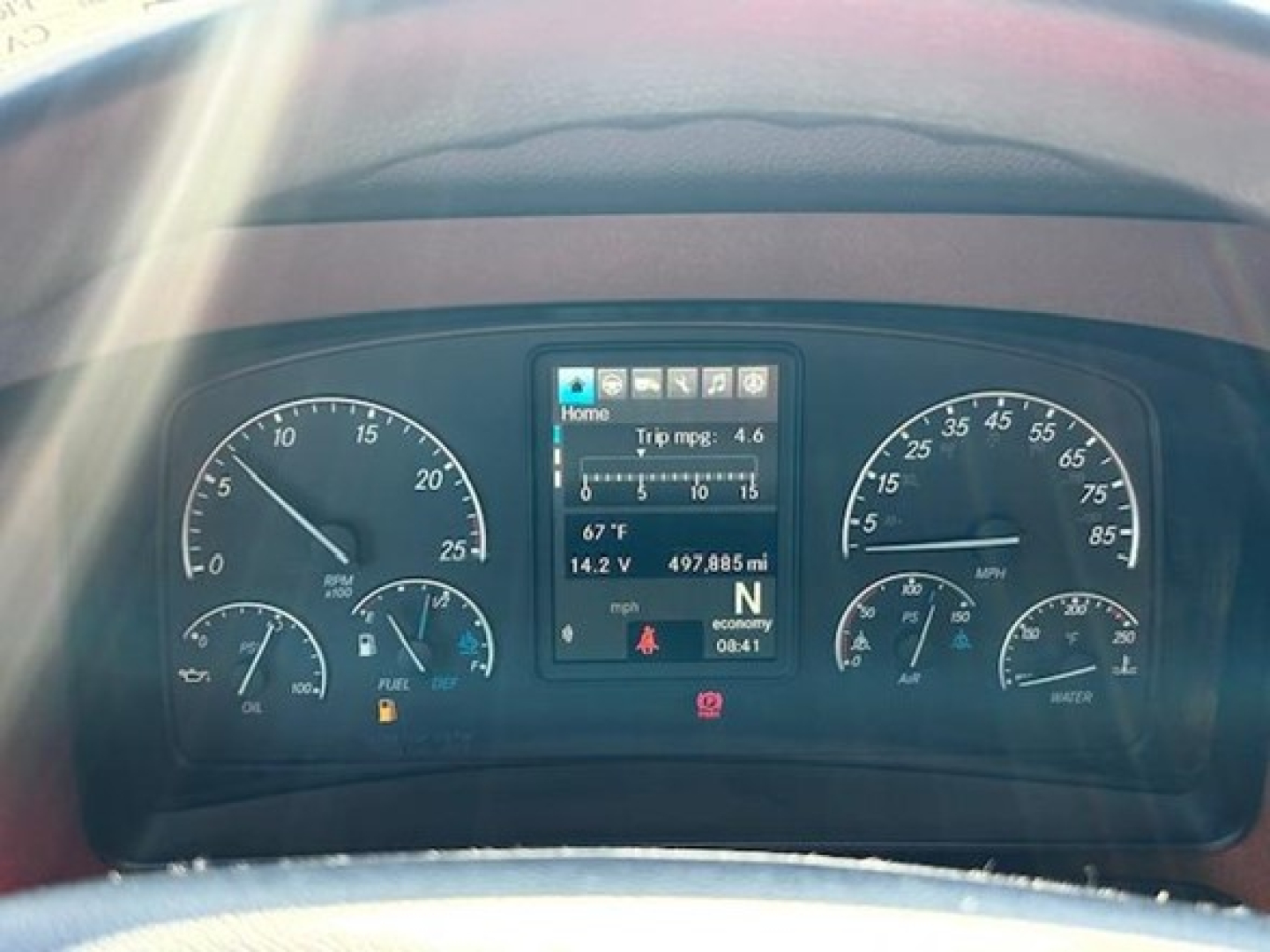 Freightliner Cascadia dashboard instruments and center display displaying trip info and gauges.