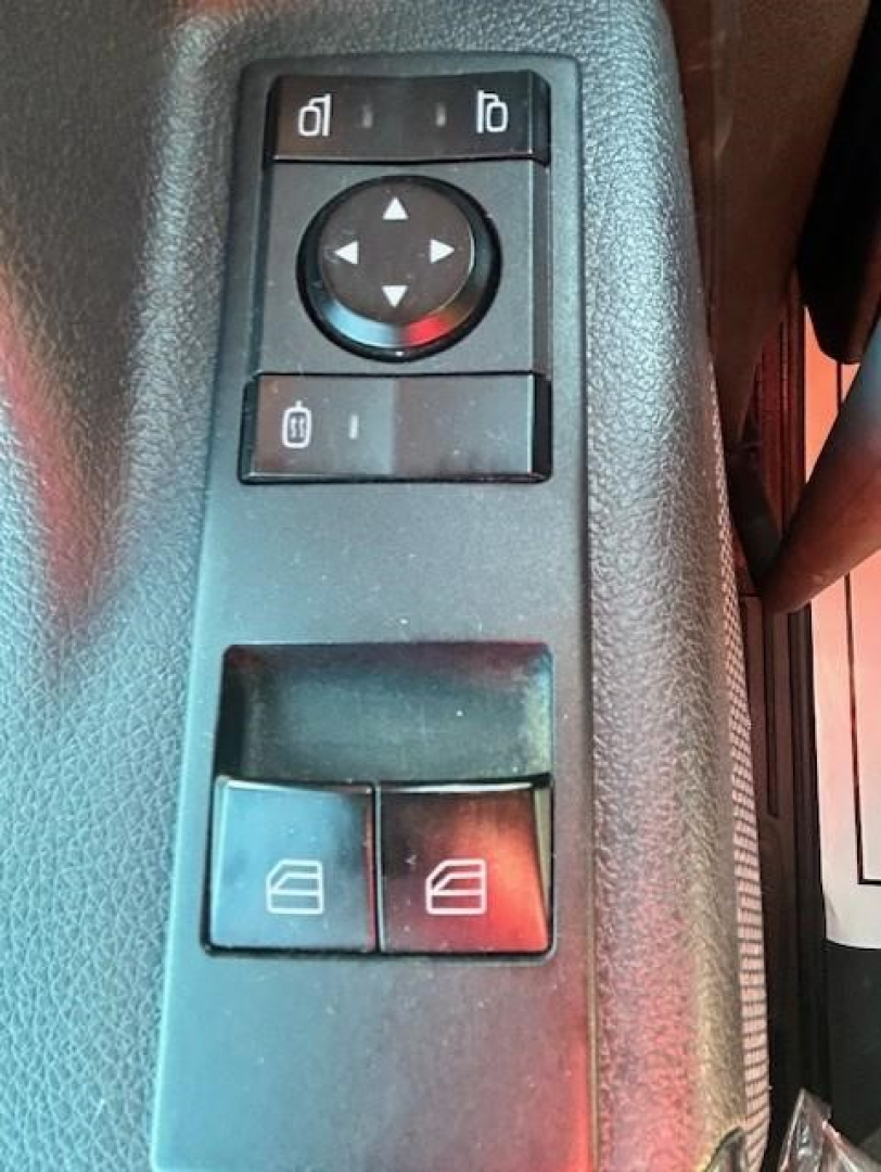 Trucker's interior door/control panel with circular directional pad and window/lock switches; visible panels show multiple buttons.