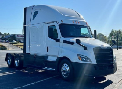 Freightliner Cascadia 126 semi-truck tractor in white, front-right view with sleeper cab and black grille; no visible text on the vehicle.