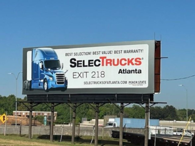 Billboard trailer truck advert for SelectTrucks Atlanta along with blue truck image.