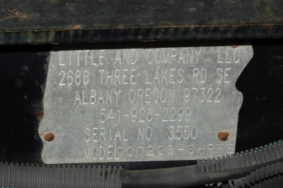 Metal identification plate with stamped text on equipment showing Little and Company LLC address in Albany Oregon, serial number 3550, Model 203-CHP etc.