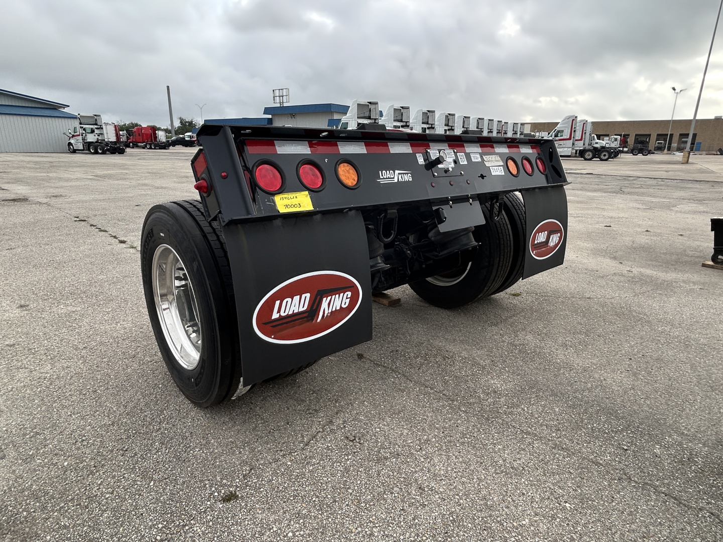 Load King FL241-43-60 flip axle trailer rear view showing dual axles, mud flaps with Load King logo, and underside hardware.