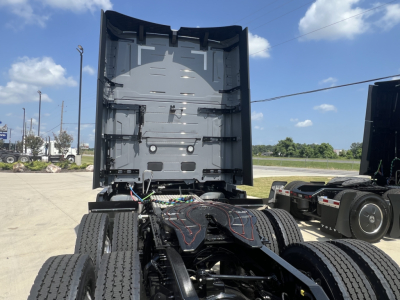 Volvo VNL64T860 truck rear view showing fifth wheel and chassis with exposed wiring harnesses.