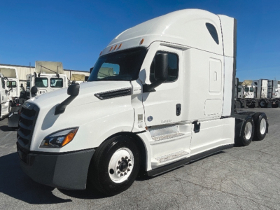 Truck cab front-left view of a white 2022 Freightliner Cascadia126 sleeper tractor with dual rear axles and VIN plate area visible.