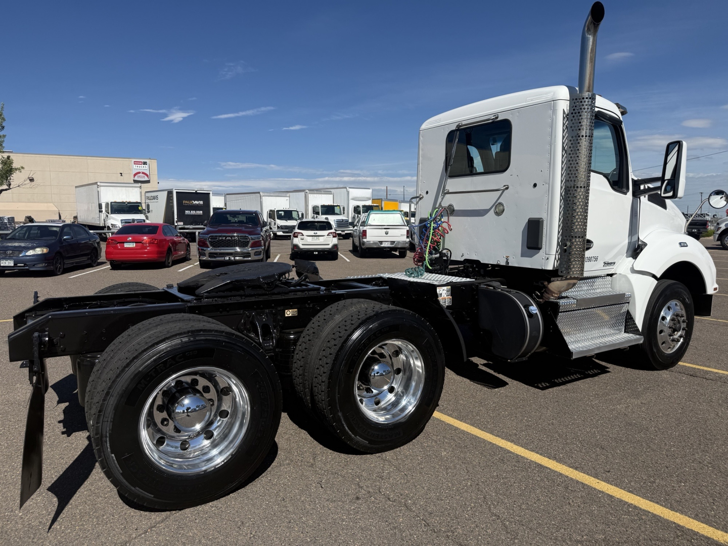Kenworth T880 daycab tractor rear chassis and cab side view with dual rear axle and polished wheels.