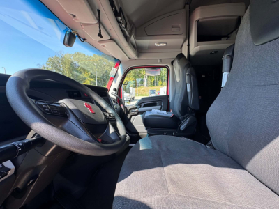 Kenworth T680 truck cab interior with steering wheel, driver seat, and dashboard view.