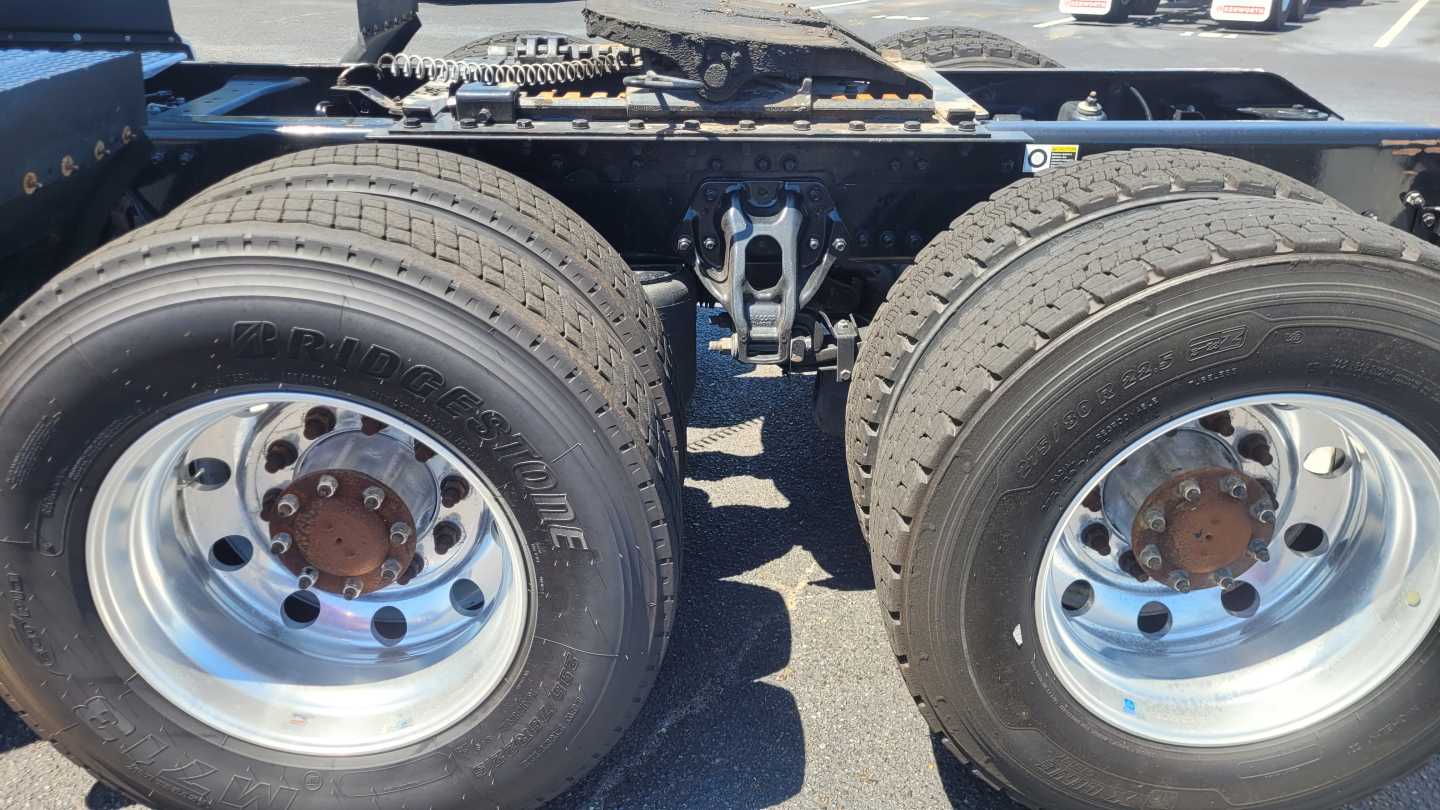 Kenworth T680 chassis showing dual rear axles with Bridgestone tires and polished wheels.