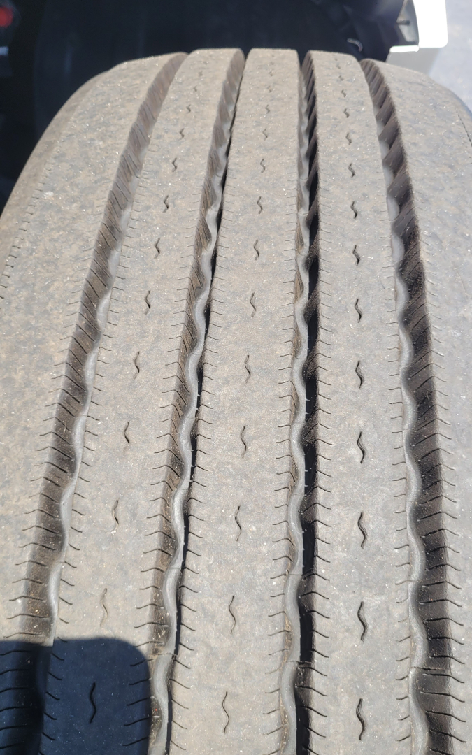 Tandem wheel tread close-up with visible wear on tires.