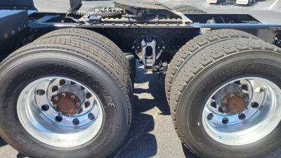 Kenworth T680 chassis showing dual rear axles with Bridgestone tires and polished wheels.