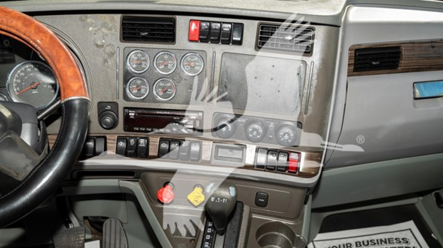 Kenworth T680 dash and steering wheel in-cab view showing gauges and controls.