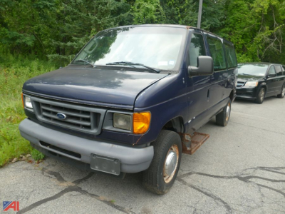 Ford E-350 cargo van in view showing front grille and side step, blue exterior, XL trim, posed on road.