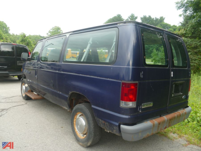 Blue 2006 Ford E350 XL Super Duty cargo van rear and passenger side view with windows, bumper, and rust on lower body.