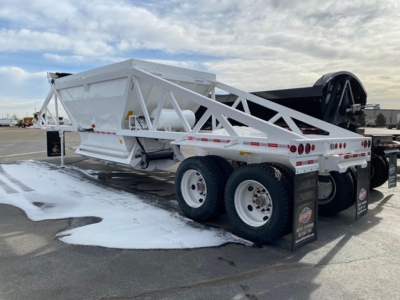 Dump trailer showing white Ranco LW21-40 lattice frame with dual axles and rear lights parked on lot.