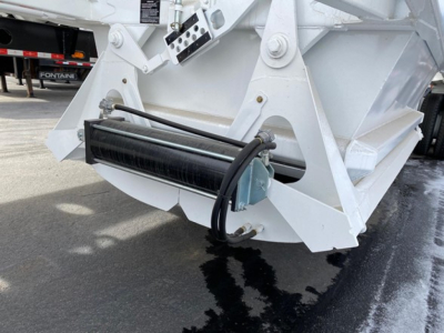 Ranco LW21-40 dump trailer component showing hydraulic cylinder and roller assembly at the front hitch area.