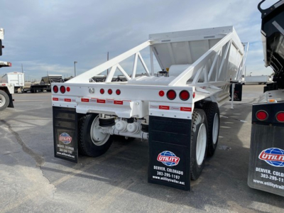 Ranco LW21-40 dump trailer rear view showing dual axles, white undercarriage, mud flaps, and tail lights.