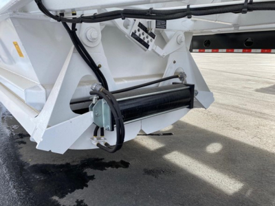 Trailer underbelly showing hydraulic winch mechanism and white paint with black rollers and wiring for Ranco LW21-40 unit.