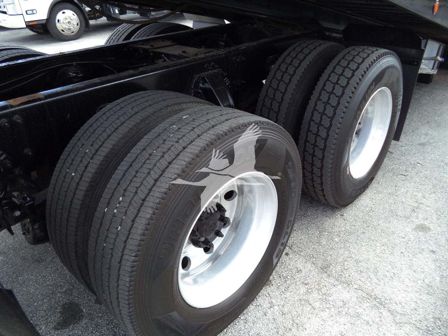 Peterbilt 348 wheel setup showing dual rear axles with unbranded tires and silver steel rims.