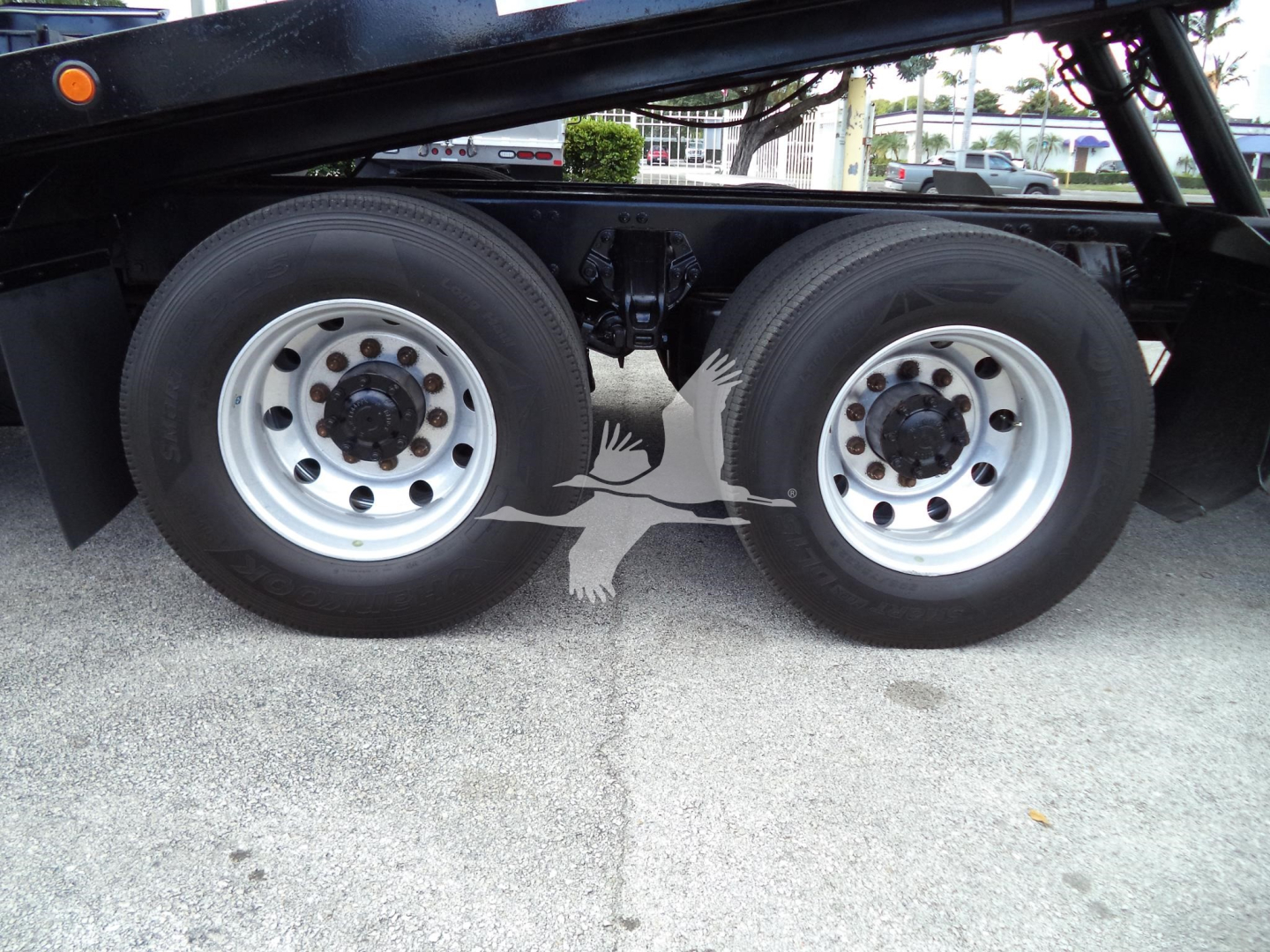 Peterbilt 348 truck dual rear wheels chassis view showing white rims and black frame