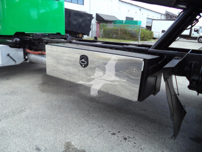 Aluminum toolbox mounted under the chassis of a 2016 Peterbilt 348 rollback truck showing a polished rectangular storage box.