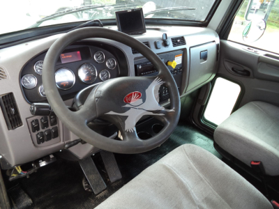 Peterbilt 348 cab interior showing steering wheel dashboard gauges and driver's seat