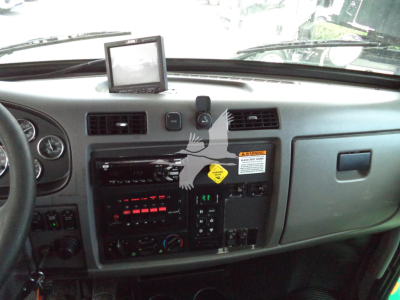 Peterbilt 348 dash and center console showing radio, climate controls, and a GPS unit mounted on top of dashboard.