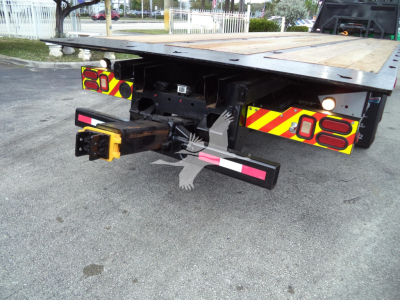 Peterbilt 348 rollback tow truck rear hitch assembly and platform view with reflective rear lights and bumper guards.