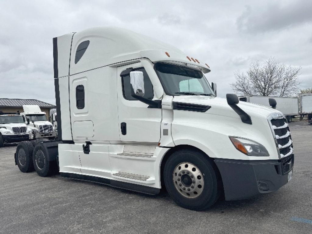 Freightliner Cascadia126 truck side view showing sleeper cab and front grille.