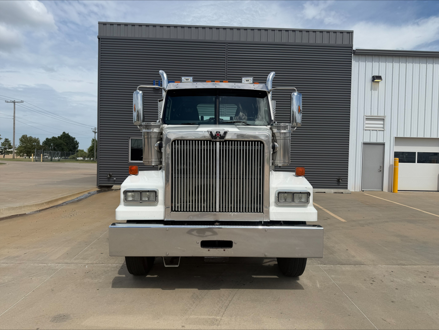 Front view of a white 2019 Western Star 4900 SF truck showing grille, bumper, and headlights.