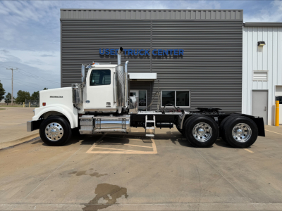 Western Star 4900 SF truck side view showing conventional daycab with chrome exhaust stacks and dual rear axles.