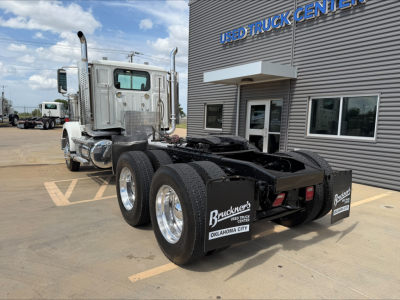 2019 Western Star 4900 SF tractor in a used truck lot, double rear axles, chrome exhaust stacks, aluminum cab, fifth wheel missing cab visible with Brackner's Oklahoma City sign.