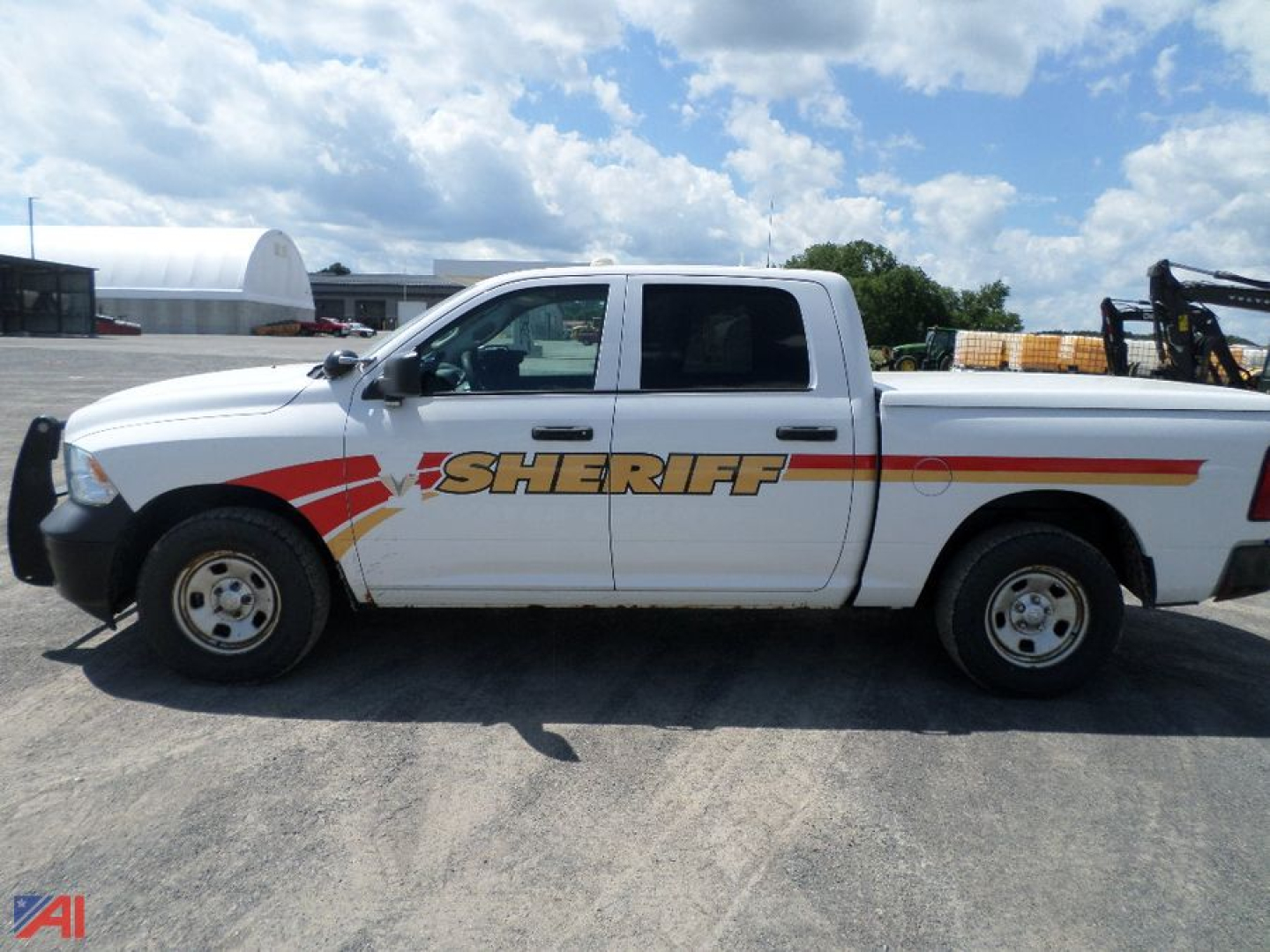 Ram 1500 crew cab pickup truck with sheriff graphics on side panel, side view showing driver door and extended cab.