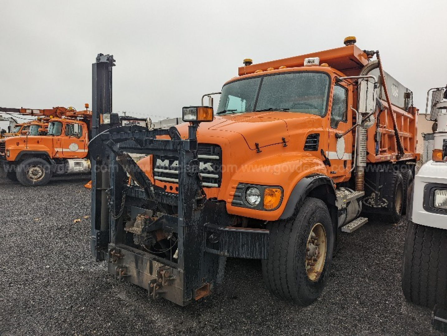 Mack CV713 Granite truck with front plow attachment in view