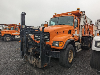 Mack CV713 Granite truck with front plow attachment in view