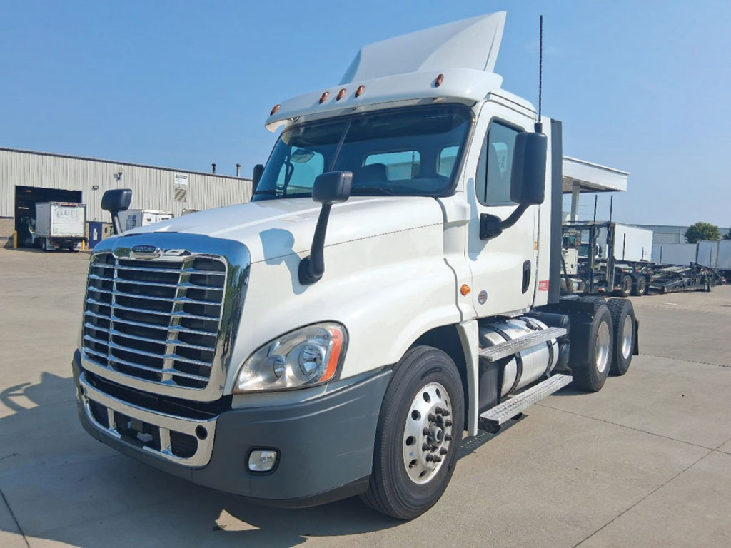 Truck cab in daylight showing Freightliner Cascadia125 badge and front grille with dual headlights.