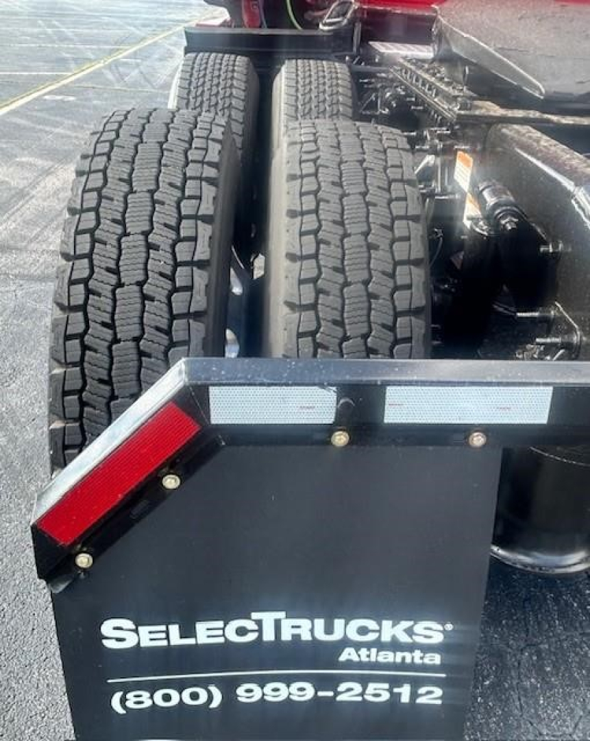 Rear view of a Freightliner Cascadia 126 tractor with dual rear axles and mudflaps showing SeleCTrucks Atlanta branding and contact number.