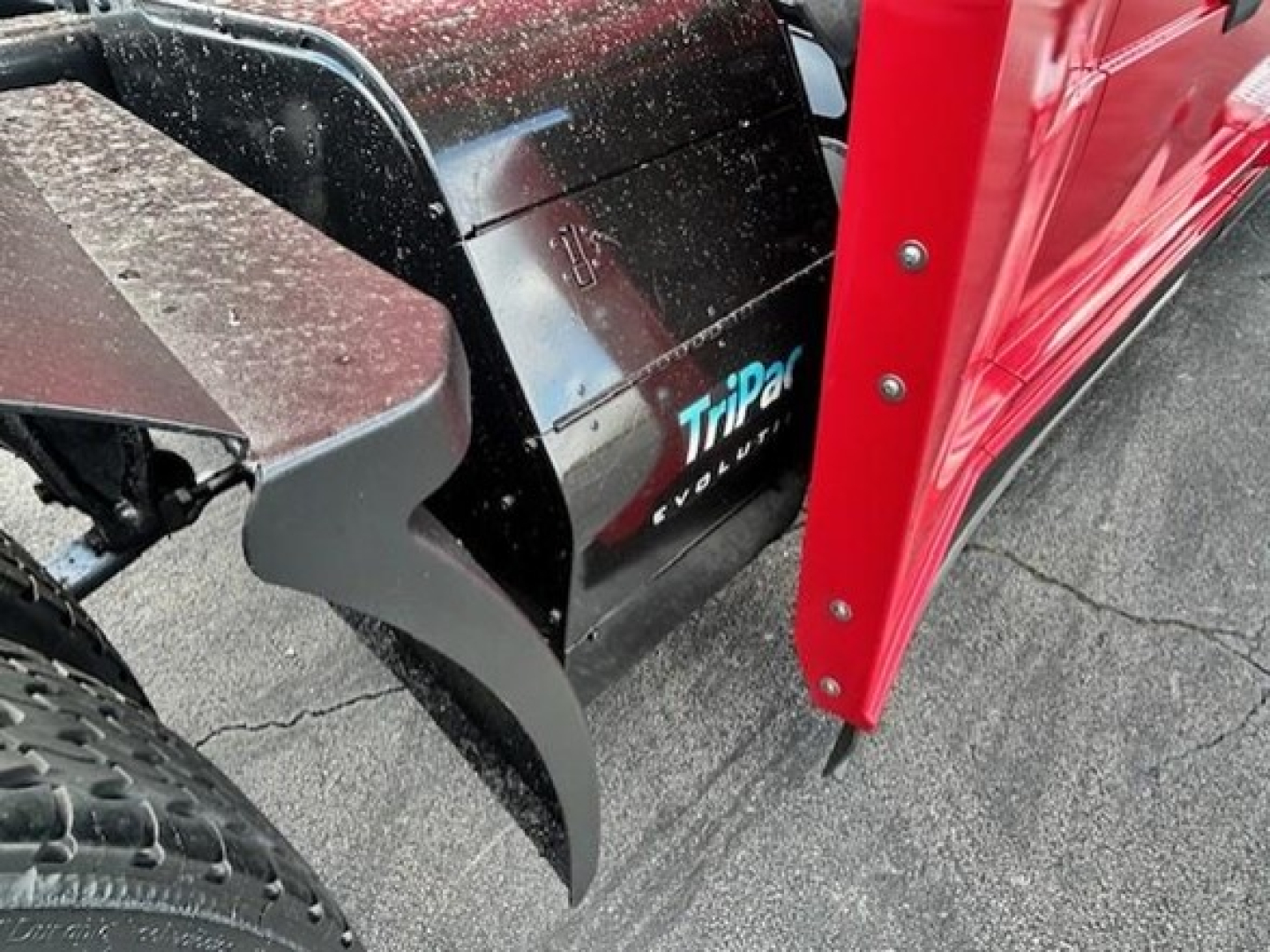 Truck front left mudguard and snow plow attachment showing TripDir EVOLUTION logo on side panel.