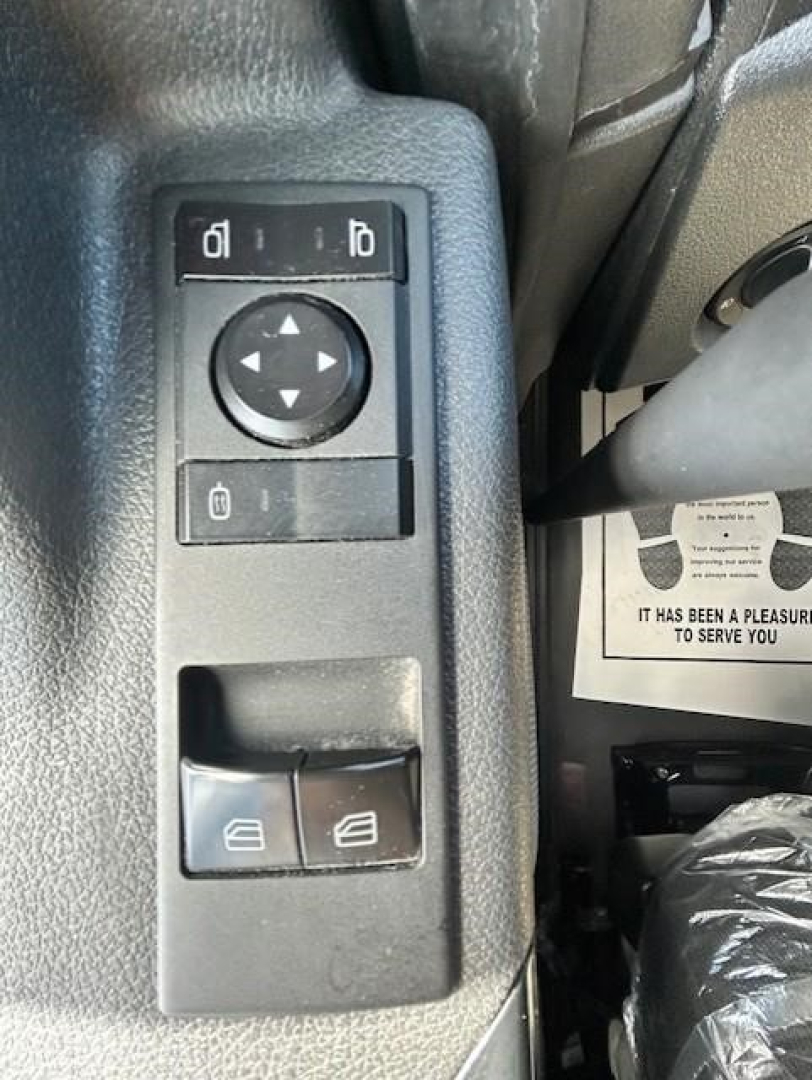 Freightliner Cascadia diecast image showing interior driver door controls with window switches and mirror adjustment pad.