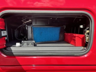 Cab area showing storage and HVAC components in a Freightliner Cascadia 126 engine bay compartment.
