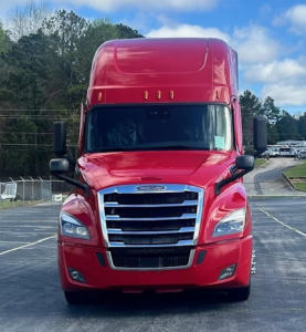 Freightliner Cascadia 126 front view showing bold chrome grille and red cab with black mirrors.