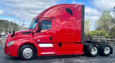 Red Freightliner Cascadia 126 sleeper cab side view with chrome wheels and triple rear axles.