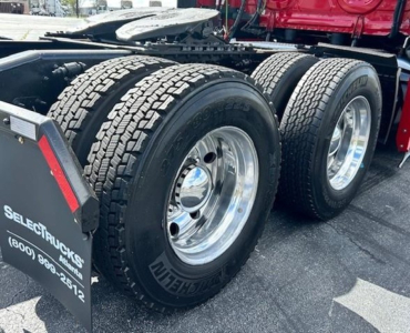 Tractor trailer rear dual tires and wheel rims visible on Freightliner Cascadia 126 tractor, with chrome wheels and heavy-duty dual rear axle.