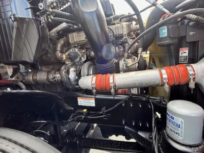 Truck engine bay of a 2023 Freightliner Cascadia 126 showing components and hoses in view