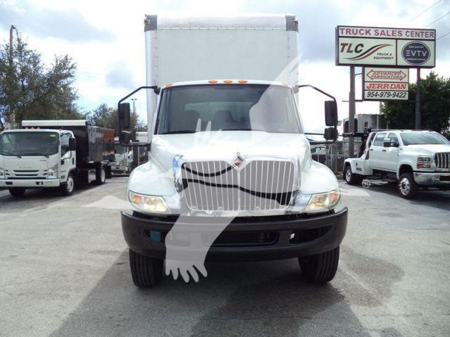 Front view of a white 2020 International MV box truck, stock number T29270, with large grille and cargo box, dealership lot in background.