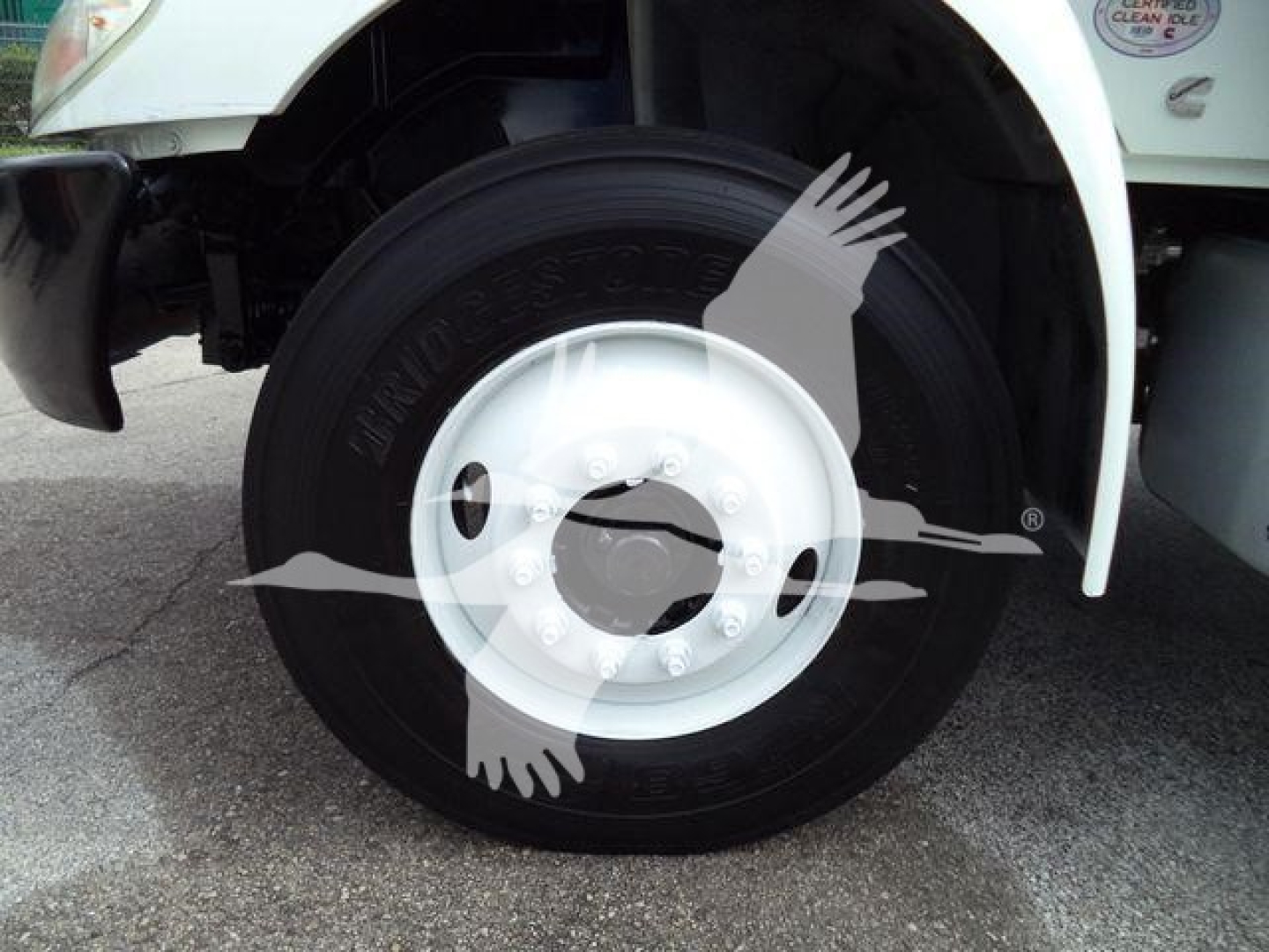 Wheel assembly of a 2020 International MV truck showing front tire and white wheel cover.