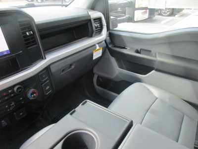 Ford F-550 service utility truck interior view showing front passenger seat, center console with cup holder, dashboard controls, and door panel.